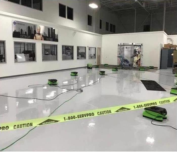Water in a warehouse with caution tape