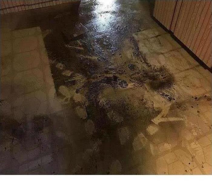 Sewage water on a tile floor in basement